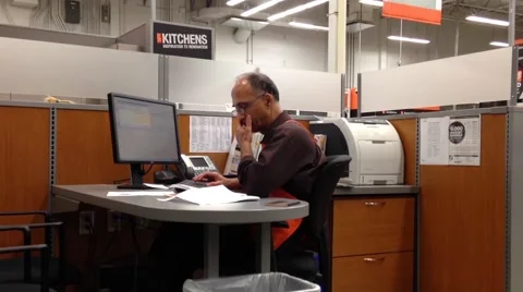 Man of Homedepot worker typing information on computer Stock Footage 54682256