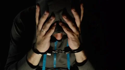The man in the hood is handcuffed Stock Footage 89354459