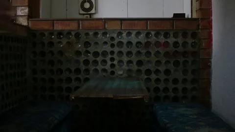 A man in a hood sits at a bar table and drinks beer2 Stock Footage 83136537