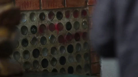 A man in a hood sits at a bar table and drinks beer Stock Footage 83136546