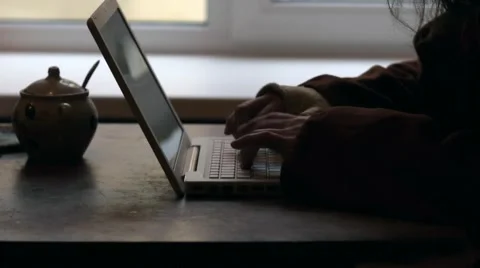 Man in hood typing on laptop Hacker Stock Footage 61009728