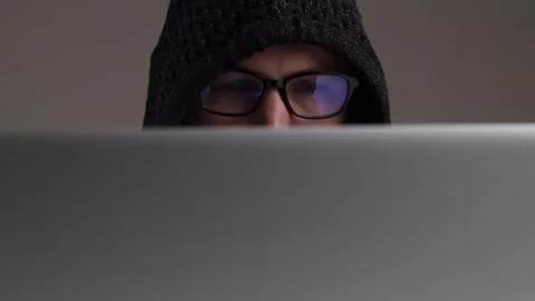 Man in hooded glasses typing while sitting on a laptop Stock-Footage 243372042