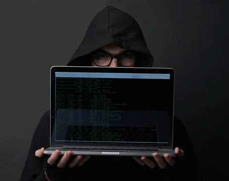 Man, hoodie and hacker in studio, laptop and fraud of cybersecurity, online and 写真素材