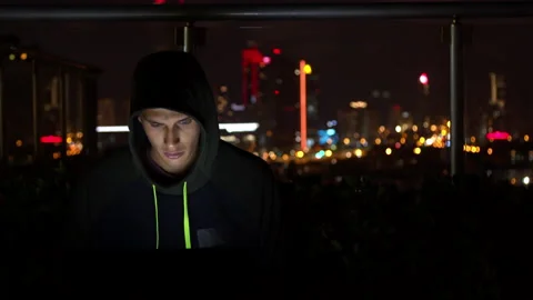 Man in hoodie hacking website at night Stock-Footage 138719797