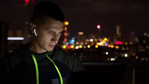 Man in hoodie hacking website at night Stock Footage 138719967