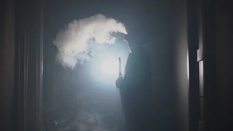 A man in a hookah exhales smoke Видео 196208377