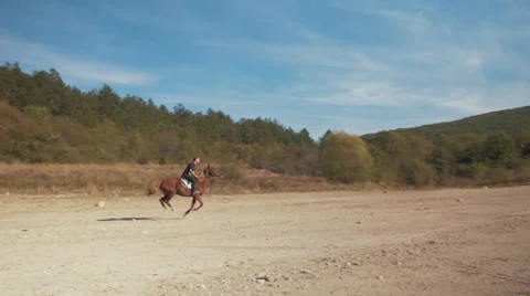 A man on a horse galloping in the mountains Stock Footage 63056041