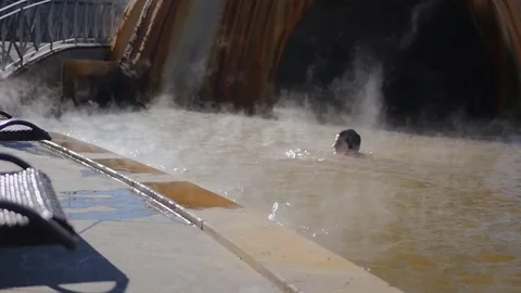 Man in hot spring geothermal pool Stock Footage 83465593