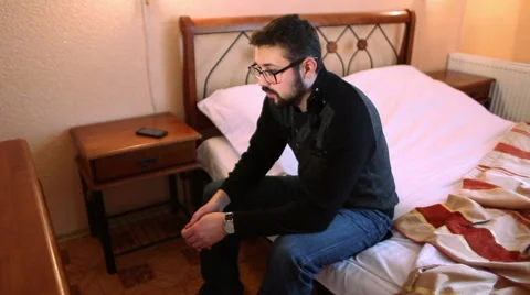 A man in a hotel room who appears to be troubled or anxious about something Video stock 59886532