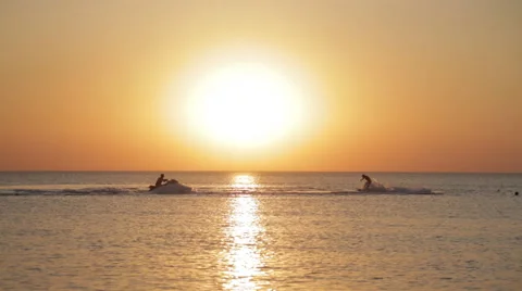 Man Hovers on a Hoverboard Over the Water on the Sunset Background Stock Footage 61472671
