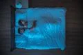 The man hug a woman on the bed. evening night time. view from above Photo