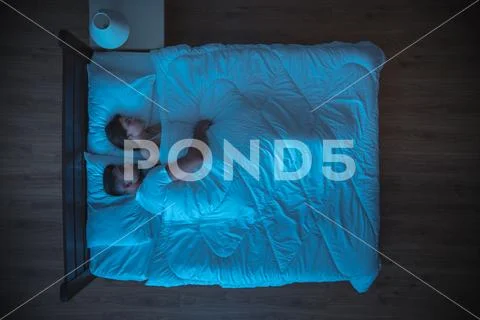 The man hug a woman on the bed. evening night time. view from above Stock Photos