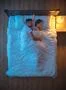 The man hug a woman on the bed. evening night time. view from above Photo