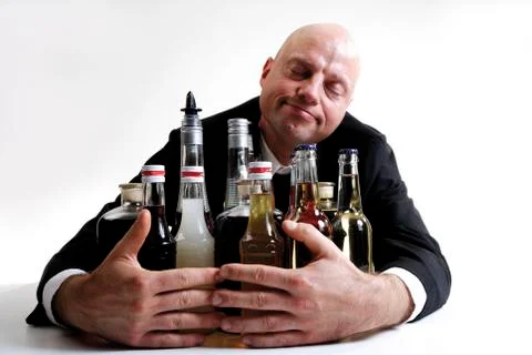 Man hugging alkohol bottles Stock Photos