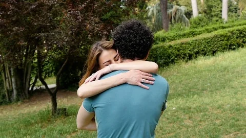 Man hugging and taking his girlfriend into the park- slow motion Stock Footage 78222417