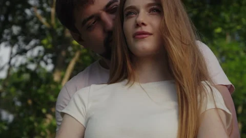 Man hugging from back her girlfriend outside in nature. Push in scene. Stock Footage 245181186