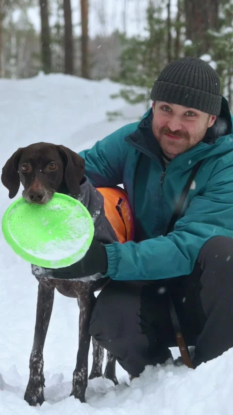 Man Hugging Dog in Snowfall Stock Footage 320803667