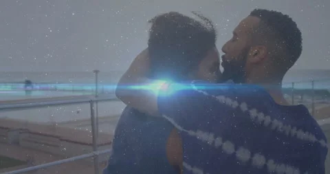 Man hugging her initiating seaside romance by deck railing, kissing forehead, Video stock 313294211