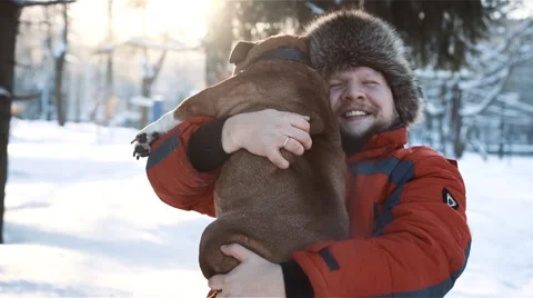 Man hugging his dog at sunny day Stock Footage