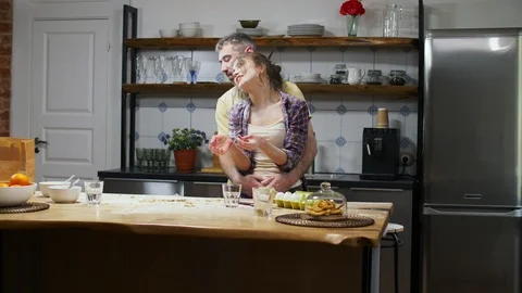Man hugging his girlfriend in kitchen Stock Footage 104608026