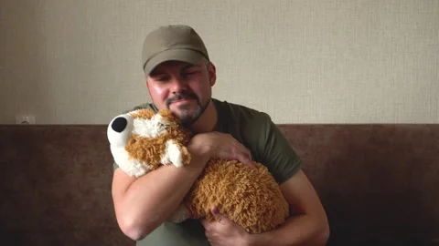 Man hugging toy corgi 4K Video stock 274402199