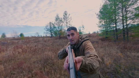 A man hunts in the forest, tracking down a target. Stock Footage 318871555