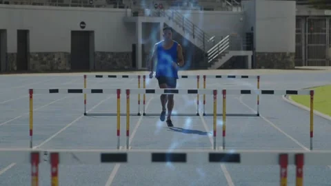 Man hurdler running track clearing hurdles training approaching hurdle sparking Vídeos de archivo 331005636