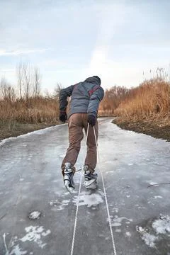 Man ice skating pulling sledge on ice Stock Photos