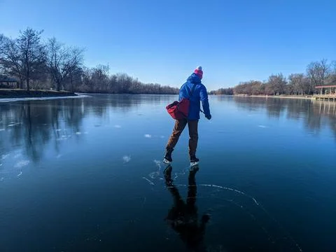 Man Ice Skating on Smooth Clear Black Ice at Toronto Island 스톡 사진