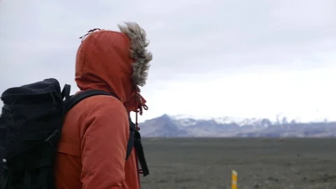 A man in iceland looking at mountains Video stock 104370573