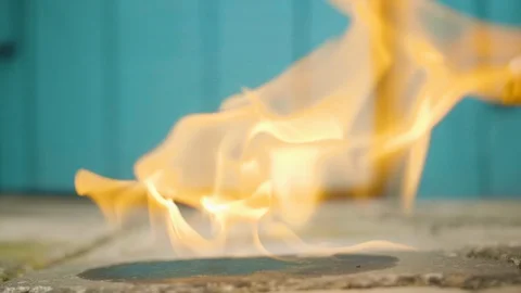 Man ignite gasoline on the ground using the lighter in slowmo Stock Footage 112689966