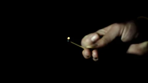 Man ignites a match in the dark close up 動画素材 74691100