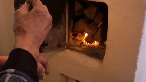 Man ignites oven. Rustic oven Stock Footage 102384626