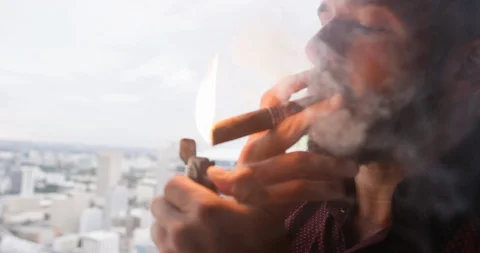 Man igniting cigar with lighter Stock Footage 116347541