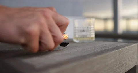 Man igniting cigar with lighter Stock Footage 116348195