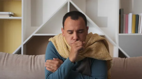 Man is ill and feels ill. Coughs from a cold. Stock Footage 134873144