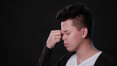 A Man Immitating Headache Against a Black Background Stock Footage 87319202