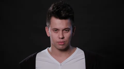 A Man Immitating Headache Against a Black Background Stock Footage 87388527