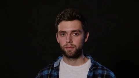 A Man Immitating Headache Against a Black Background Stock Footage 88439830
