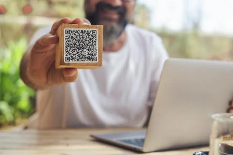 Man inbackgorund showing qr code menu at the cafe. Digital online modern pe.. Stock Photos
