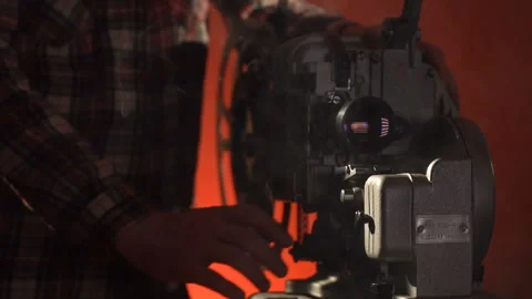 A man includes video projector a on red blackround Stock-Footage 86069059