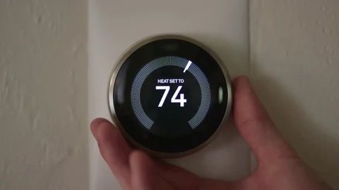 Man Increasing Temperature of Smart Thermostat Gadget At Home Video stock 75253875