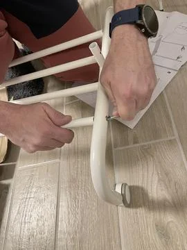 Man independently assembles a clothes hanger on wheels. Home improvement. Tools Stock-Fotos