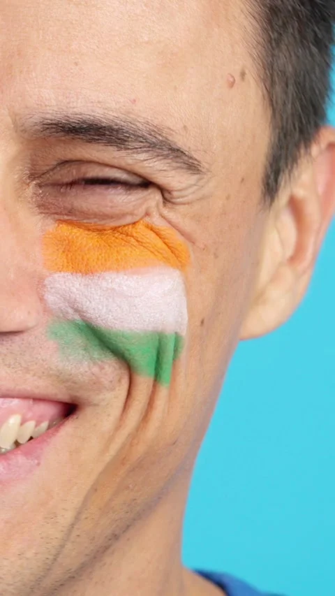 Man with a indian flag painted on the face smiling Stock Footage 261395258
