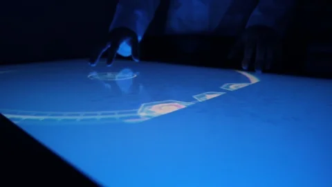 Man indicators on sensor touch screen sensory interactive table in the dark. Stock Footage 106339369