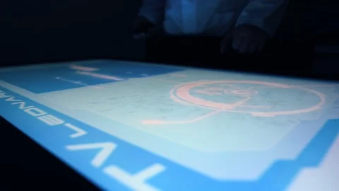 Man indicators on sensor touch screen sensory interactive table in the dark. Stock Footage 106339534