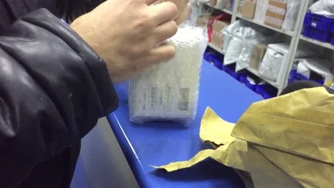 The man indoor receives the parcel at the post office. Mail international Stock Footage 83102392