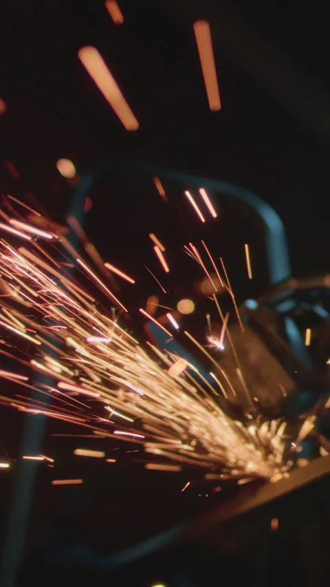 Man industrial worker or construction worker cuts metal with a grinder. Male Stock Footage 348252512