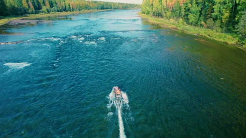 A man on an inflatable boat with a long tail rises against the current. Stock Footage 294306316