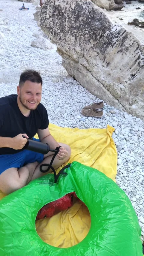 Man inflate circe on the beach Stock Footage 172043791